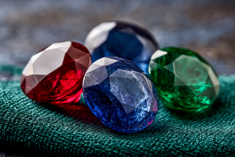 Ruby, sapphire and emerald gemstones side by side